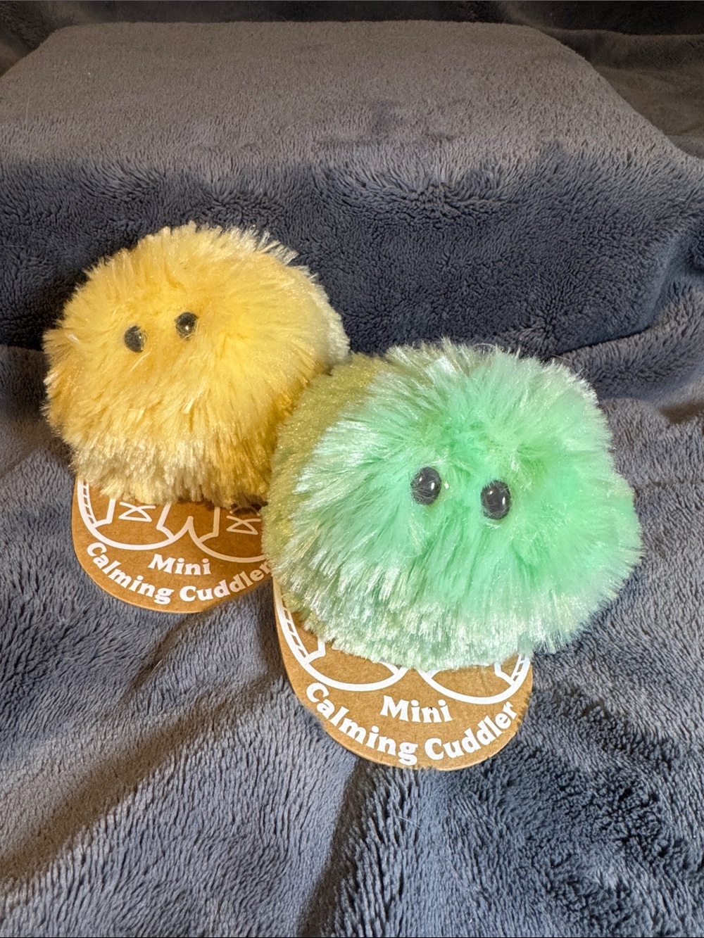 Demdaco Mini Calming Cuddlers. Set of Two, Yellow and Green Plush Puffs